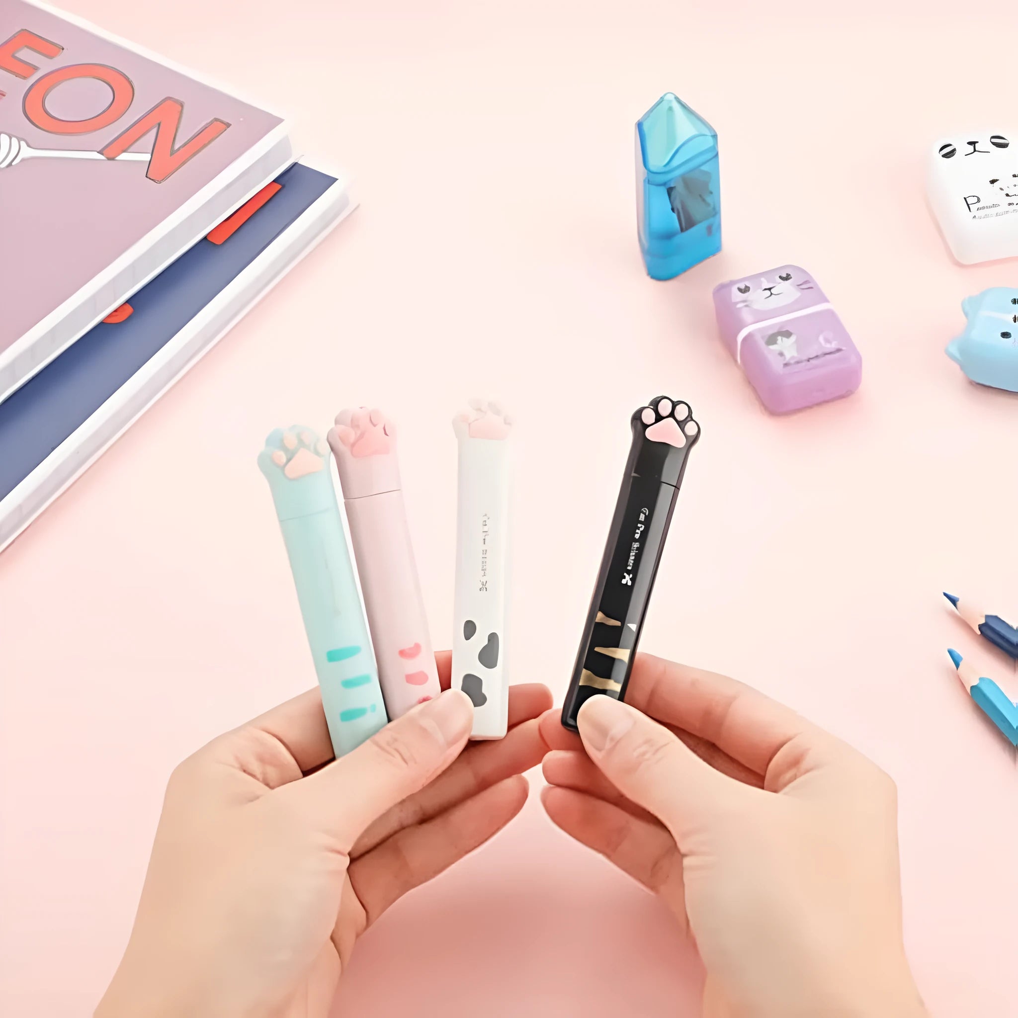 Cat paw mini folding craft scissors in four colours: black, blue, pink, and white, showing closed and open positions.