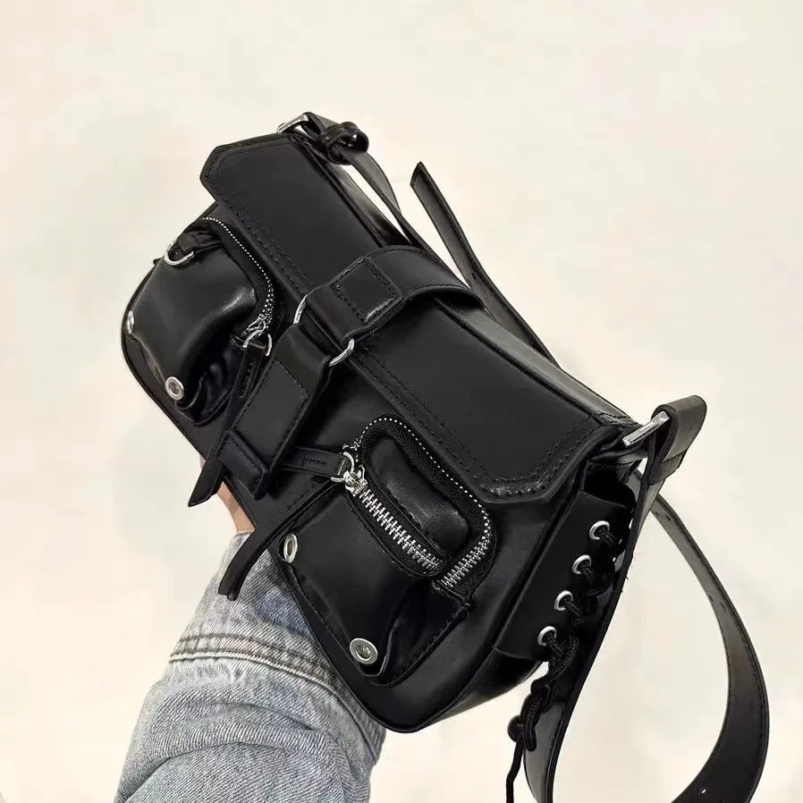 Black underarm baguette messenger bag with adjustable shoulder strap showing structured design