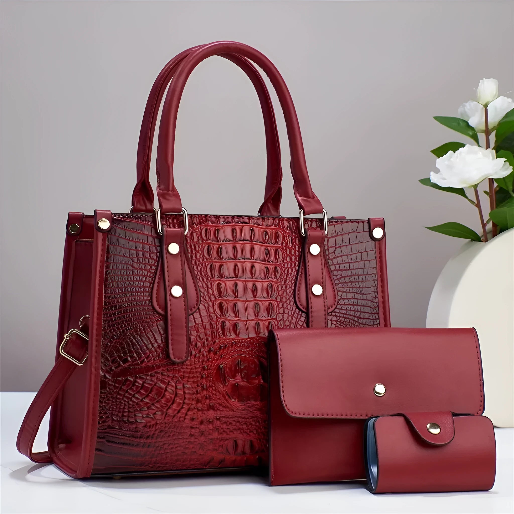 Minimalist burgundy PU leather crossbody bag three-piece set with matching wallet and card holder.