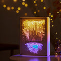 Modern bedside night light with paper carving design and remote control on wooden table