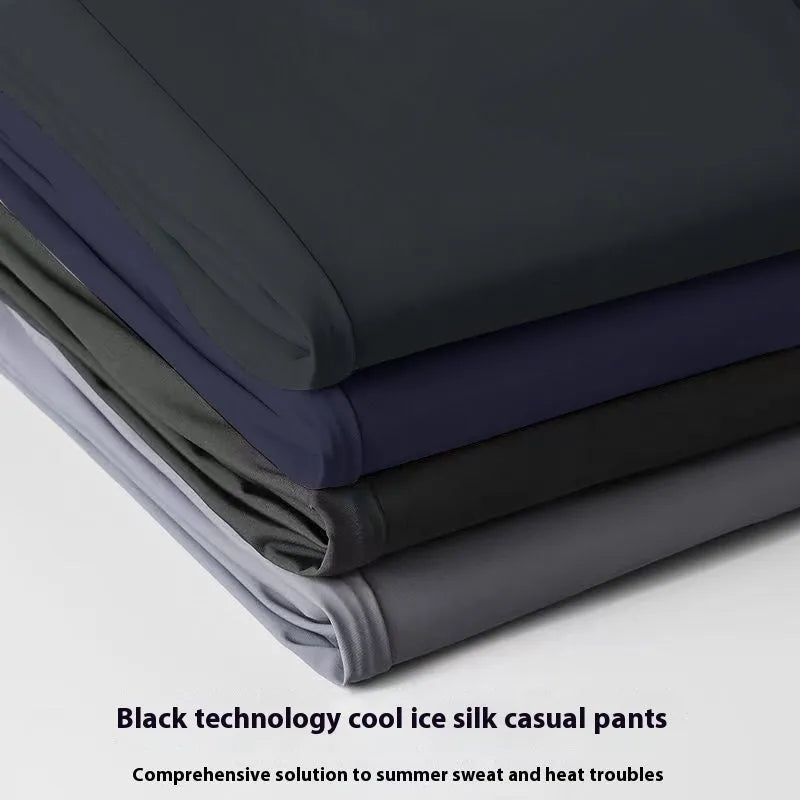 Men's black ice silk loose-fit straight leg trousers with elastic waistband laid flat.