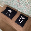 Women's black quilted computer bag with striped pattern and ballet bow detail