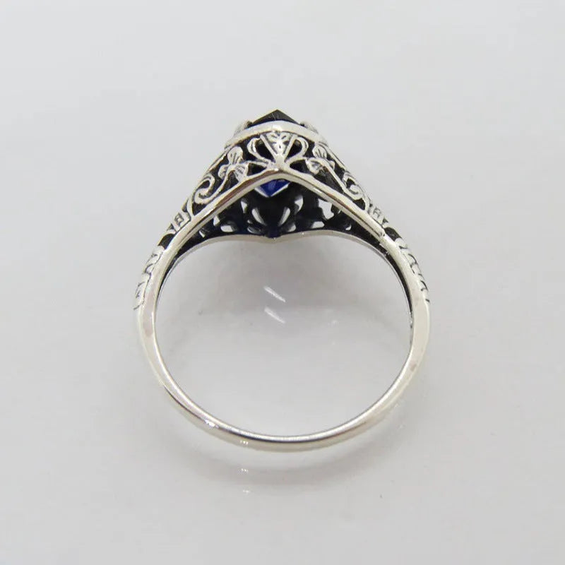 Silver alloy geometric hollow ring with zircon stone on white background, women's ring size 7