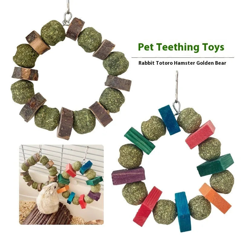 Hamster toy with applewood chew stick and colourful straw ball ring on a white background