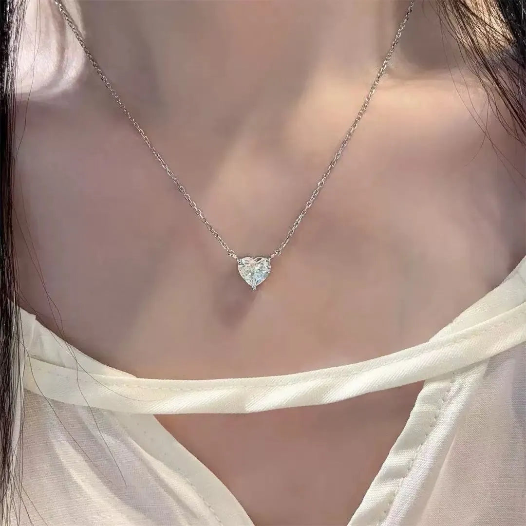 Women's simple heart-shaped copper necklace with a silver colour finish on a white background.