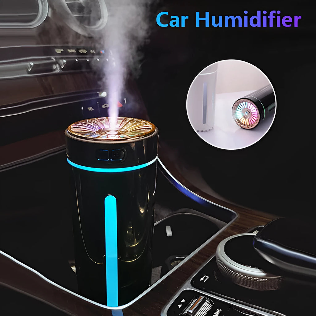 Black wireless ultrasonic humidifier with LED lights sitting in a car cup holder.