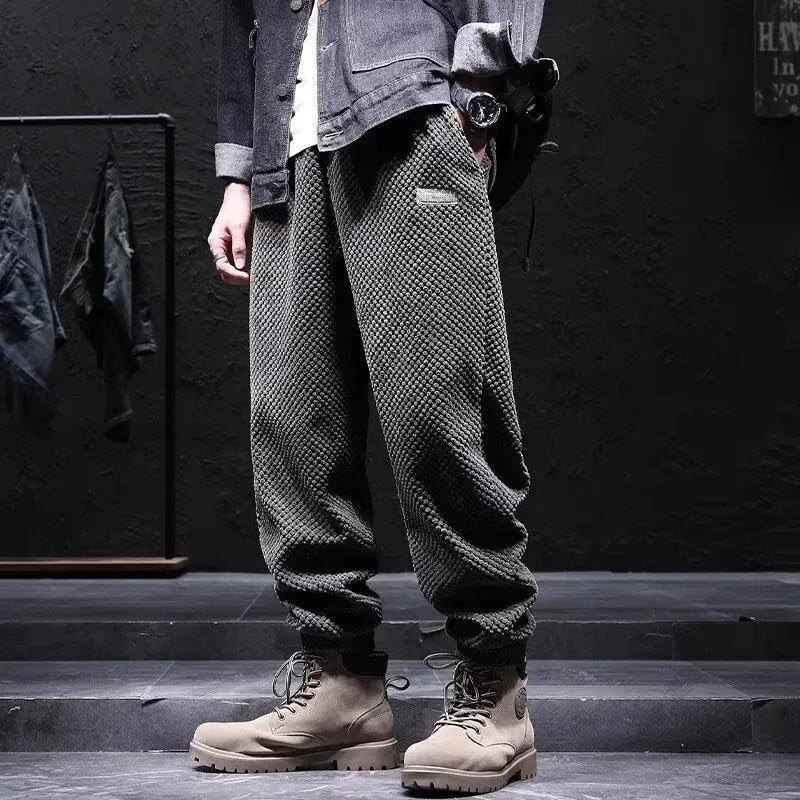 Men's grey straight-leg sweatpants with ankle ties laid flat.