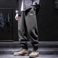 Men's grey straight-leg sweatpants with ankle ties laid flat.