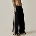 Black wide leg climbing trousers for men showing high waist and straight leg design on hanger.