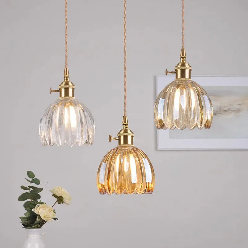 Nordic style bedside chandelier with a glass flower shade in amber, on a white background.
