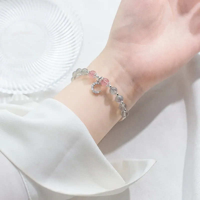 Natural moonstone adjustable bracelet with crescent moon charm and crystal accent on wrist