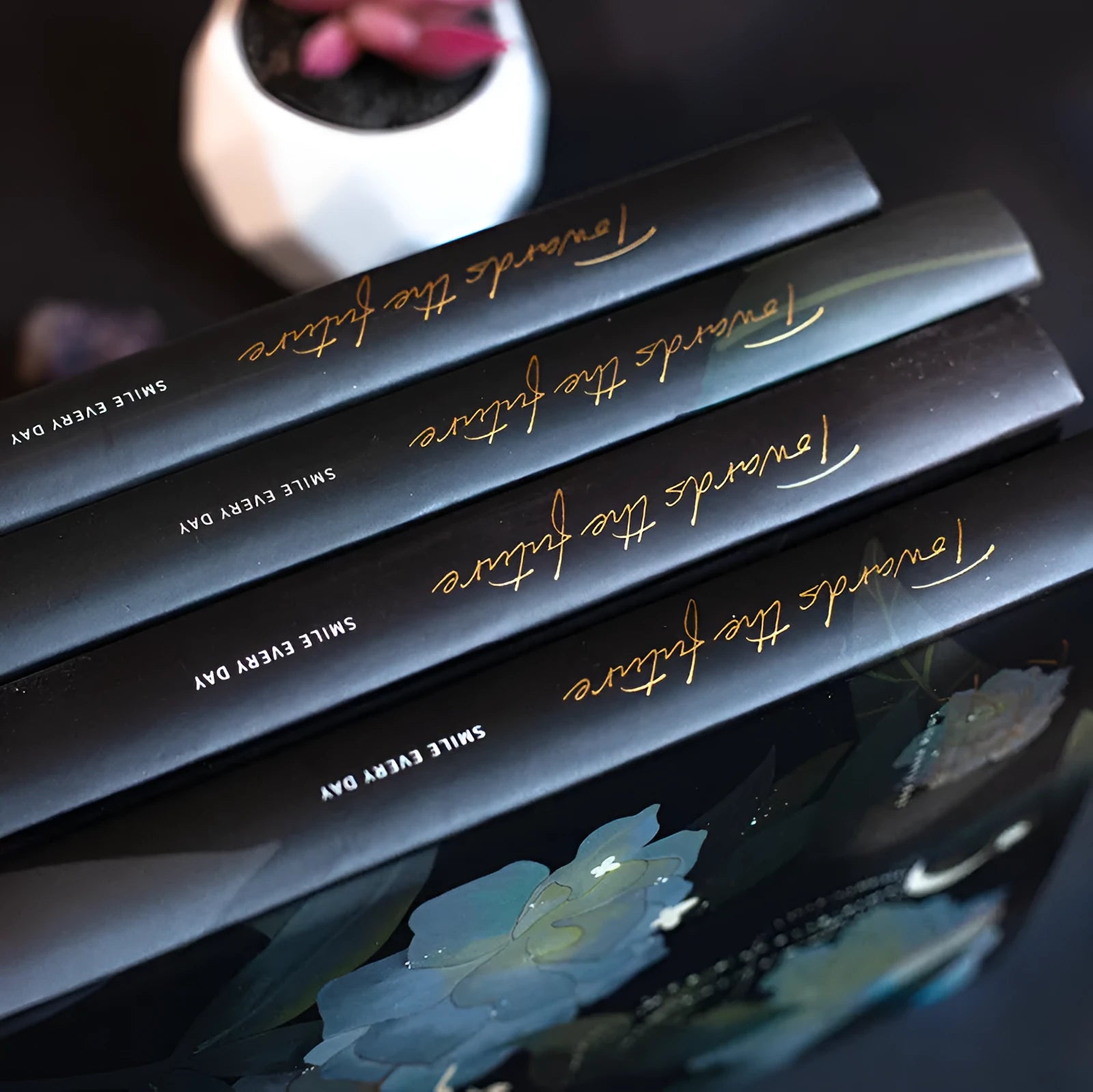 A5 notebook with luminous cover open to show pages with colour illustrations