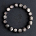 Obsidian crater ball bracelet in silver stone meteorite colour with textured round beads.