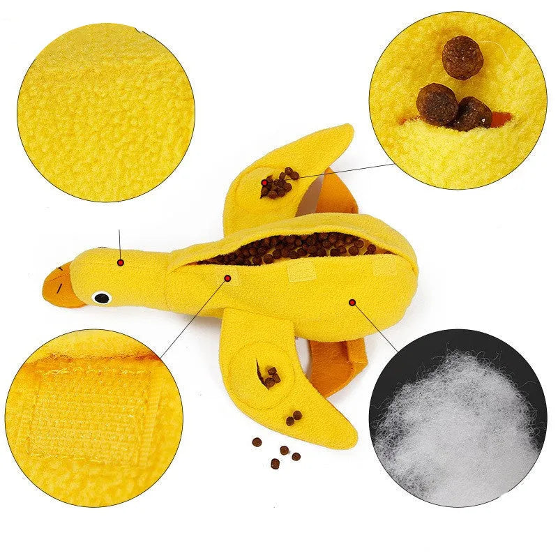 Yellow plush duck dog toy with squeaker and treat dispensing holes for training and chewing.
