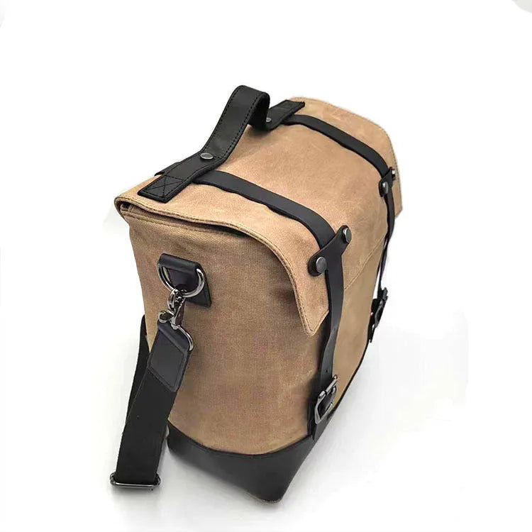 Thick waterproof canvas motorcycle side bag in black with cowhide top and adjustable straps