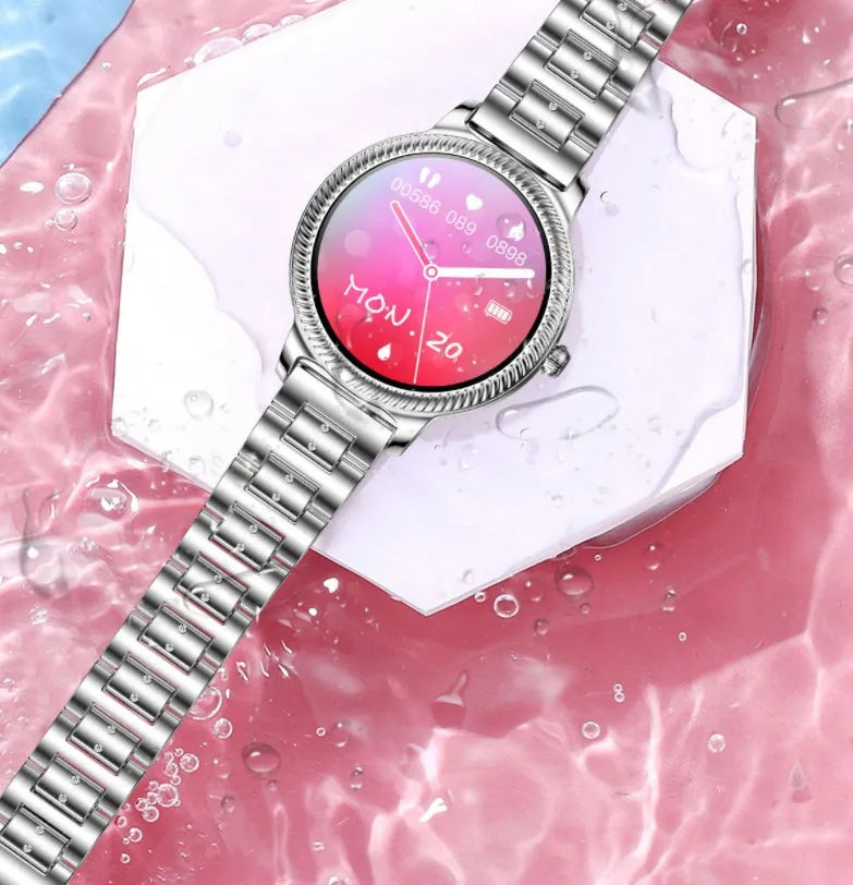 AK38 ladies smart watch with stainless steel band showing on wrist, screen displaying time.