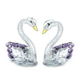 White crystal swan ornament in choice of red, blue, pink, or purple on a desktop