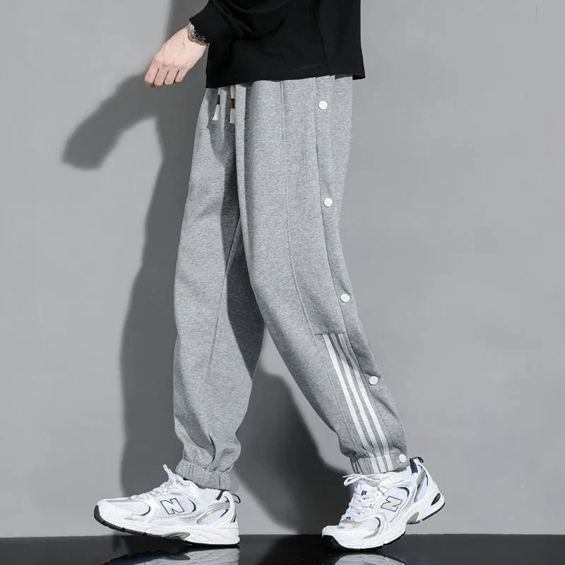 Men's black loose sports sweatpants with ankle ties and elastic high waist