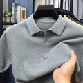 Man wearing a loose grey short sleeve cotton sweater, casual pullover style