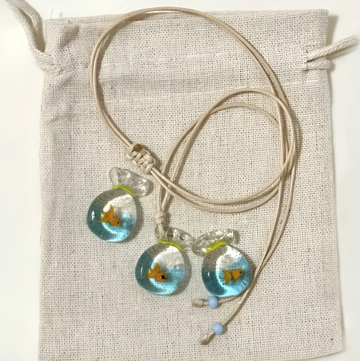 Women's joker charm pendant necklace in coloured glaze on a cotton and linen clavicle chain.