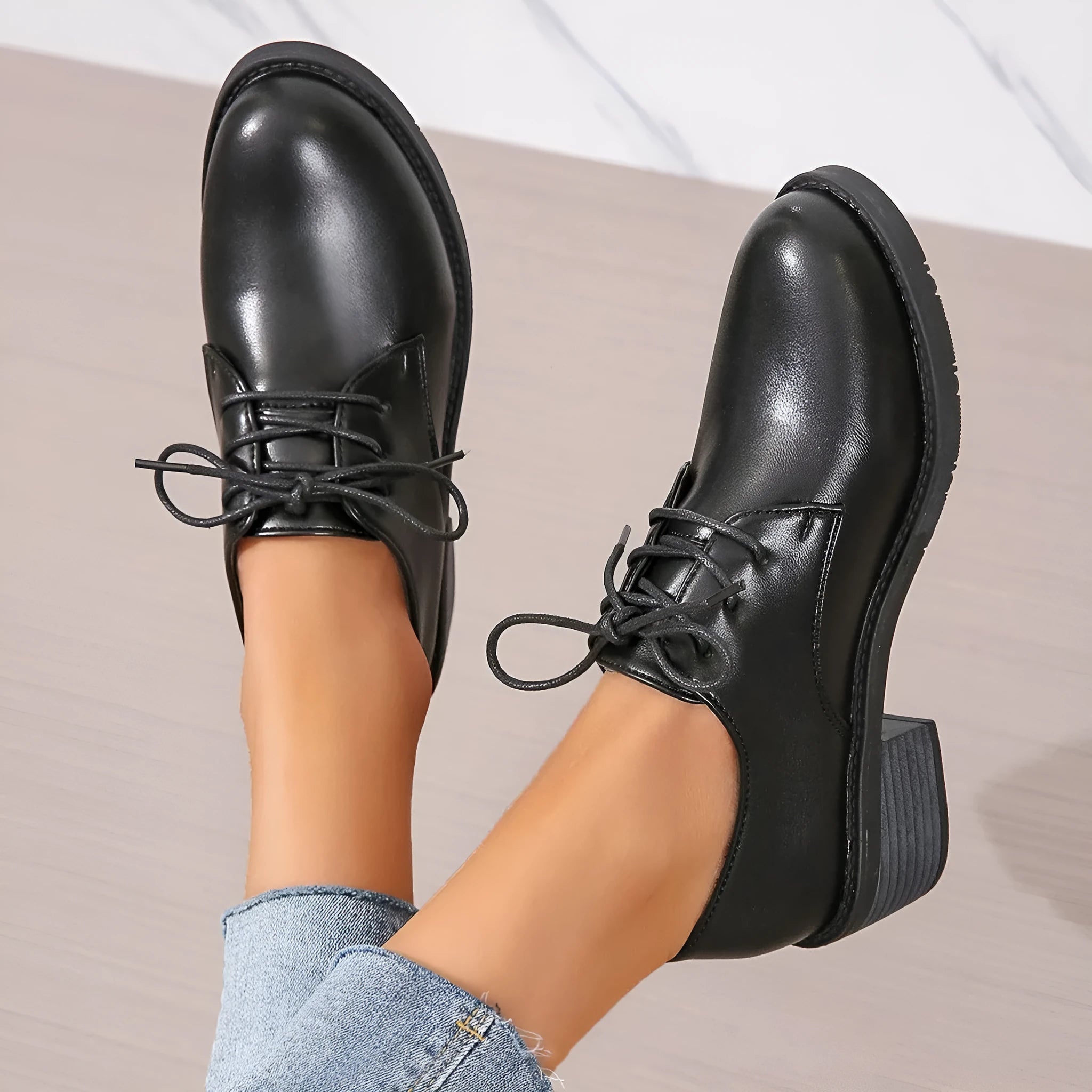 Black women's work shoes with a thick chunky heel and pointed toe.