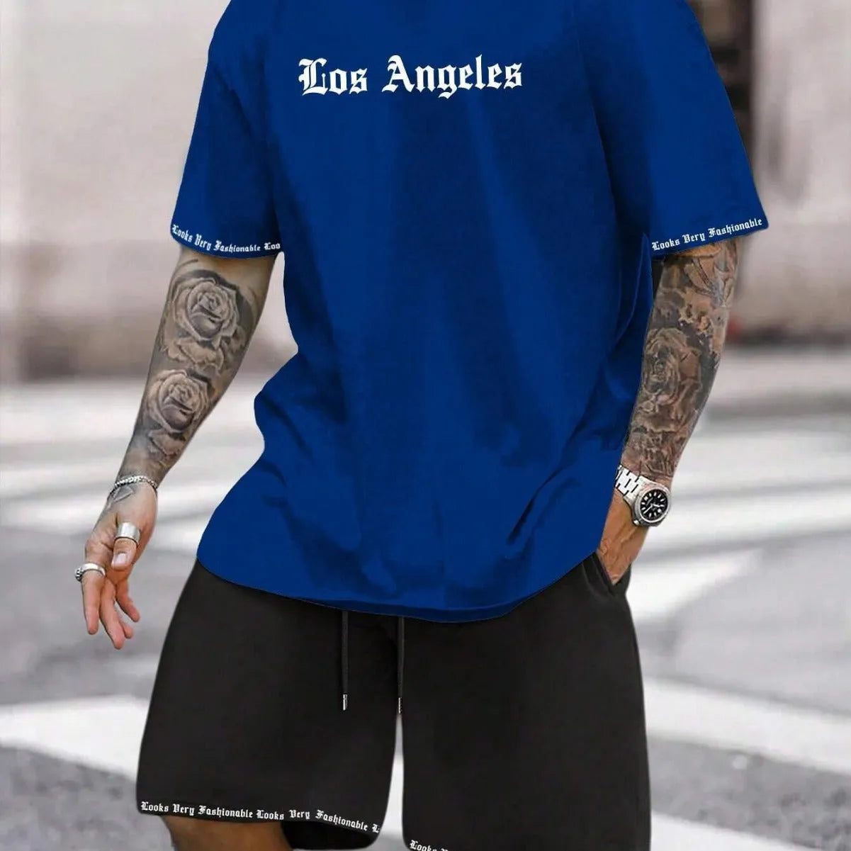 Men's navy blue printed short-sleeved top and matching shorts sports set on a white background
