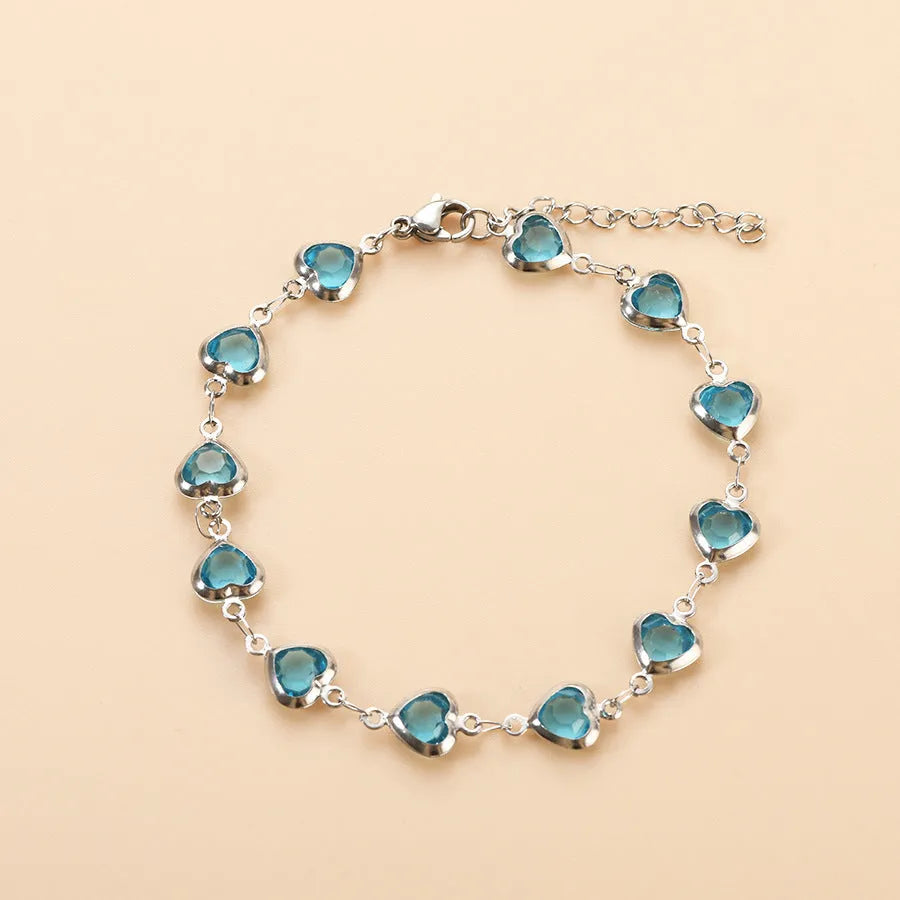 Devil's Eye Creative stainless steel heart bracelet in one of six electroplated colours on a wrist.