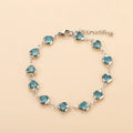 Devil's Eye Creative stainless steel heart bracelet in one of six electroplated colours on a wrist.