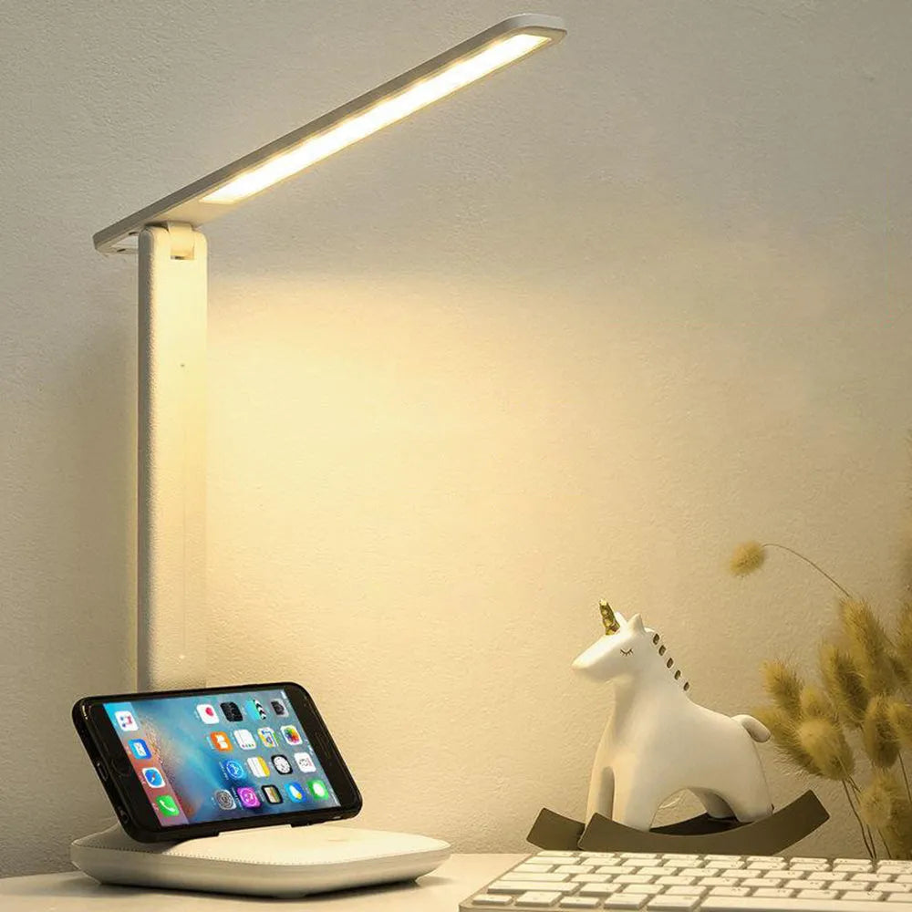 White USB rechargeable bedside lamp with touch dimming control on a wooden table.