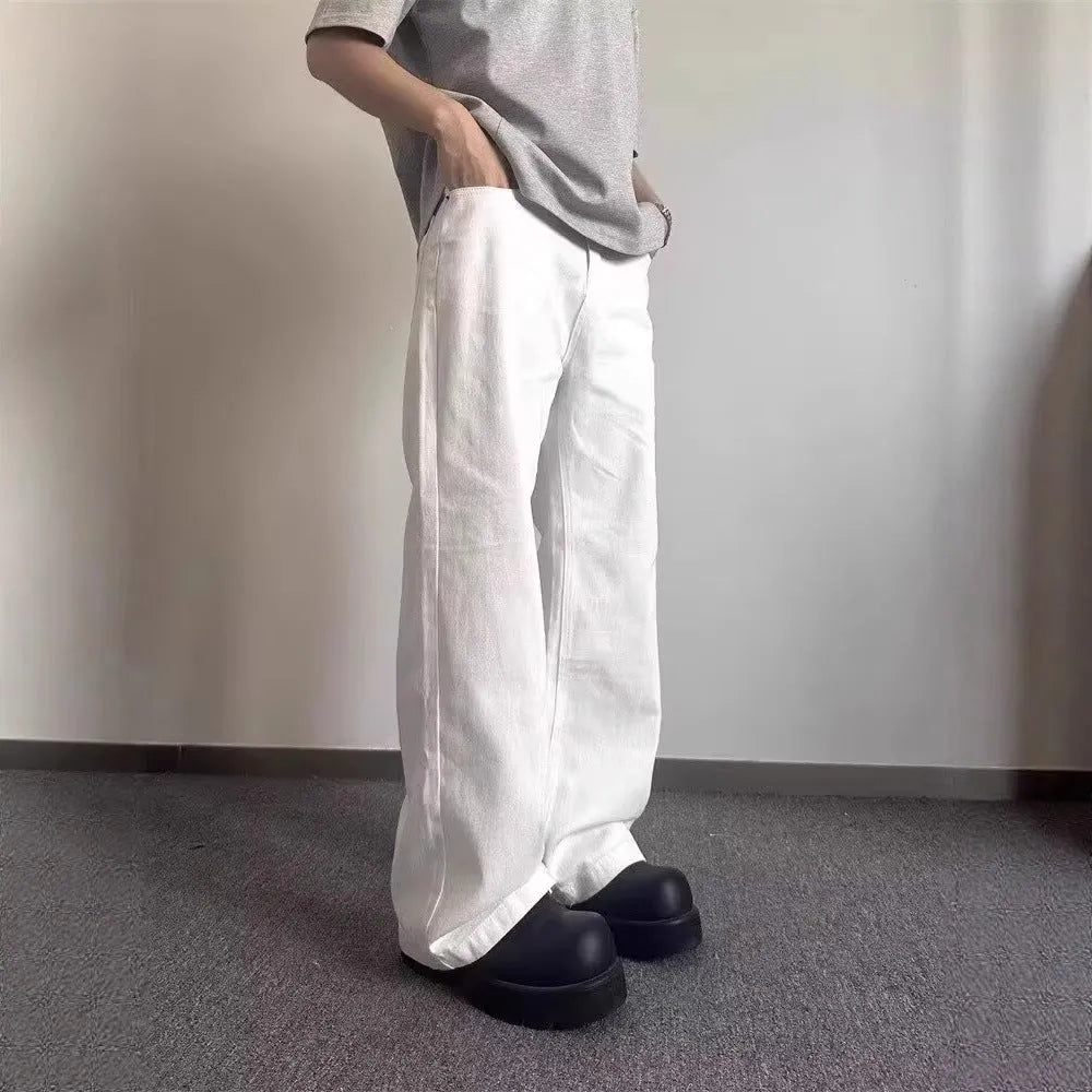 Men's white straight-leg wide fit cotton denim jeans on a neutral background.