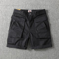 Men's straight leg cotton cargo shorts in khaki with multiple pockets and elastic waistband.