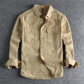 A man wearing a loose fit light grey long sleeve polyester cardigan shirt