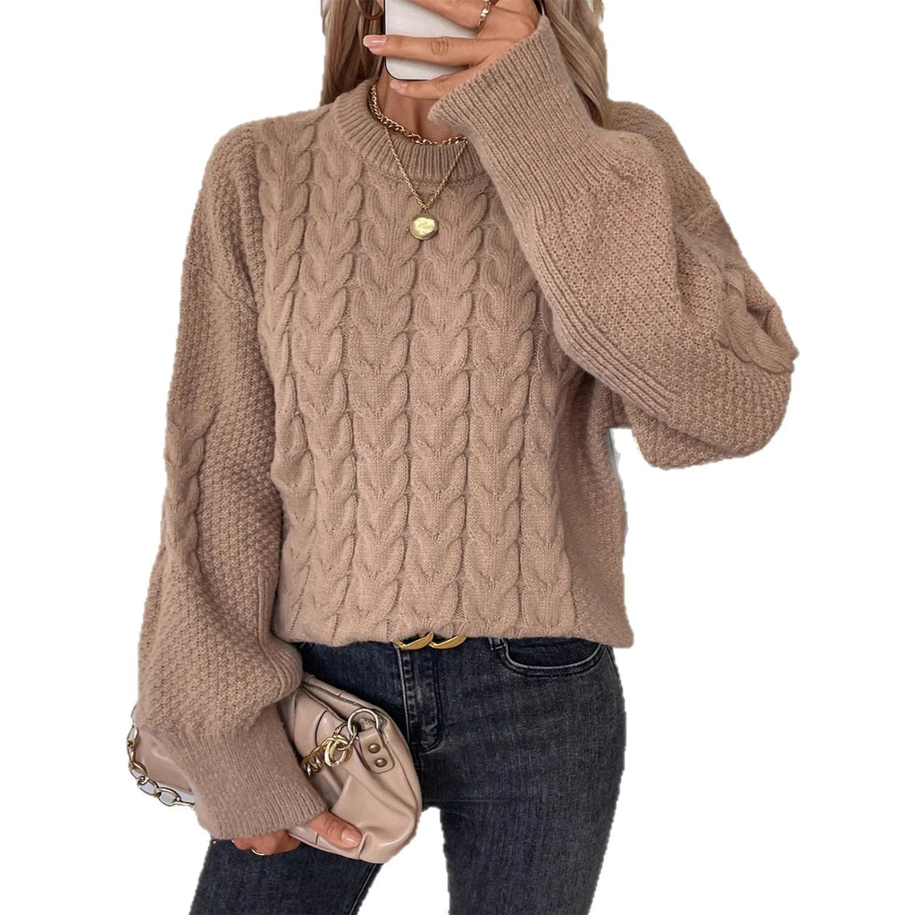 A woman's loose-fit round neck sweater in a solid colour, shown in a casual street fashion style.