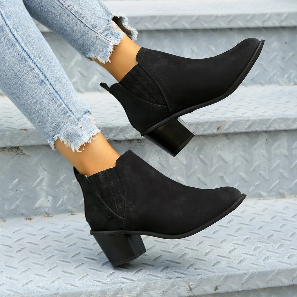 Women's black ankle boots with pointed toe, thick square heel and slip-on design