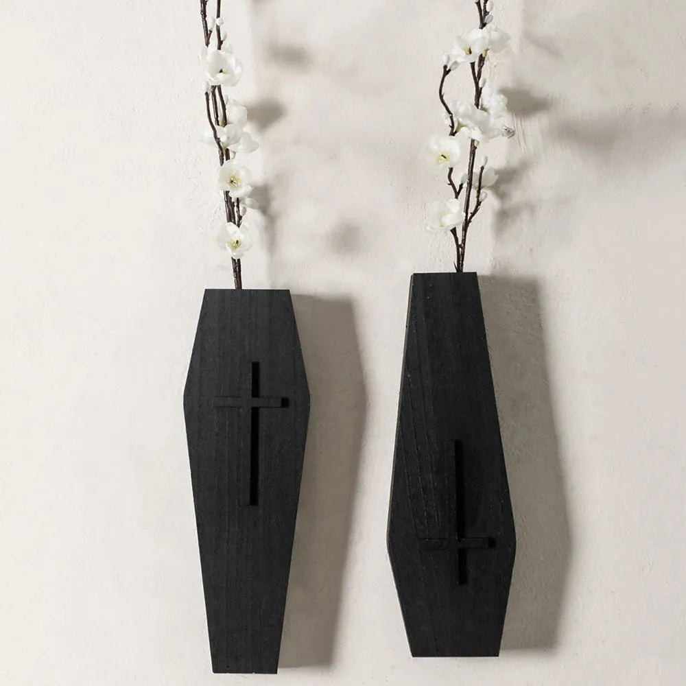 Black cross-shaped wooden wall vase shelf with a compact 27 cm ledge for holding a small vase or ornament