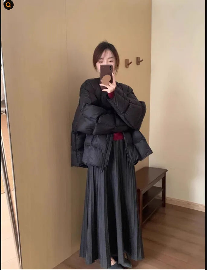 Women's dark grey knitted dress suit set with sweater and skirt showing 3D knit pattern and collage stitching