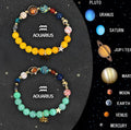 Two natural stone beaded bracelets for Chinese Zodiac signs laid side by side.