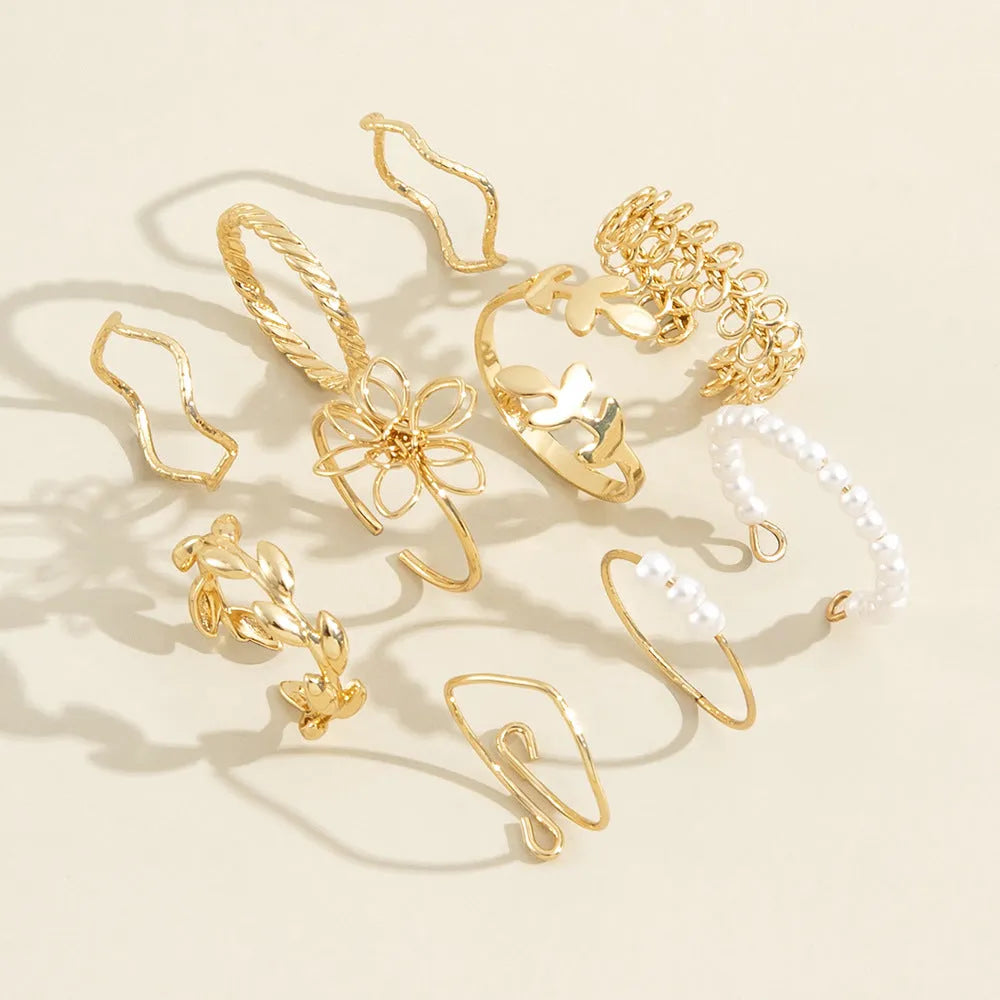 Women's gold alloy ring with openwork flower design and glossy electroplated finish