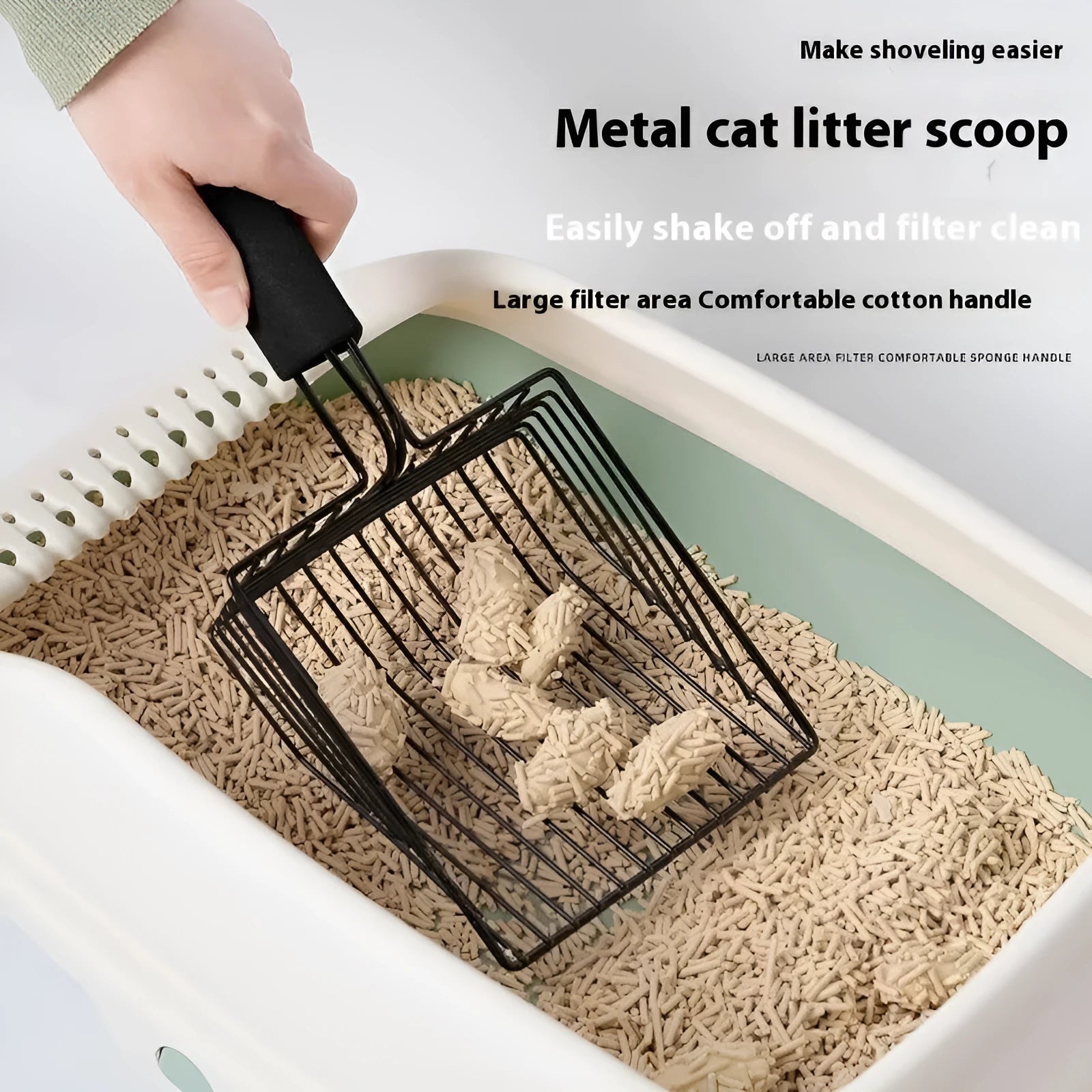 Black metal cat litter scoop with narrow tines for sifting waste from litter.