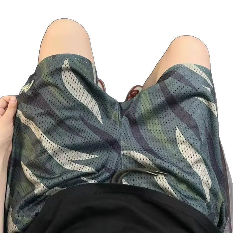 Men's camouflage coloured straight-leg mesh shorts made from a cotton blend fabric.