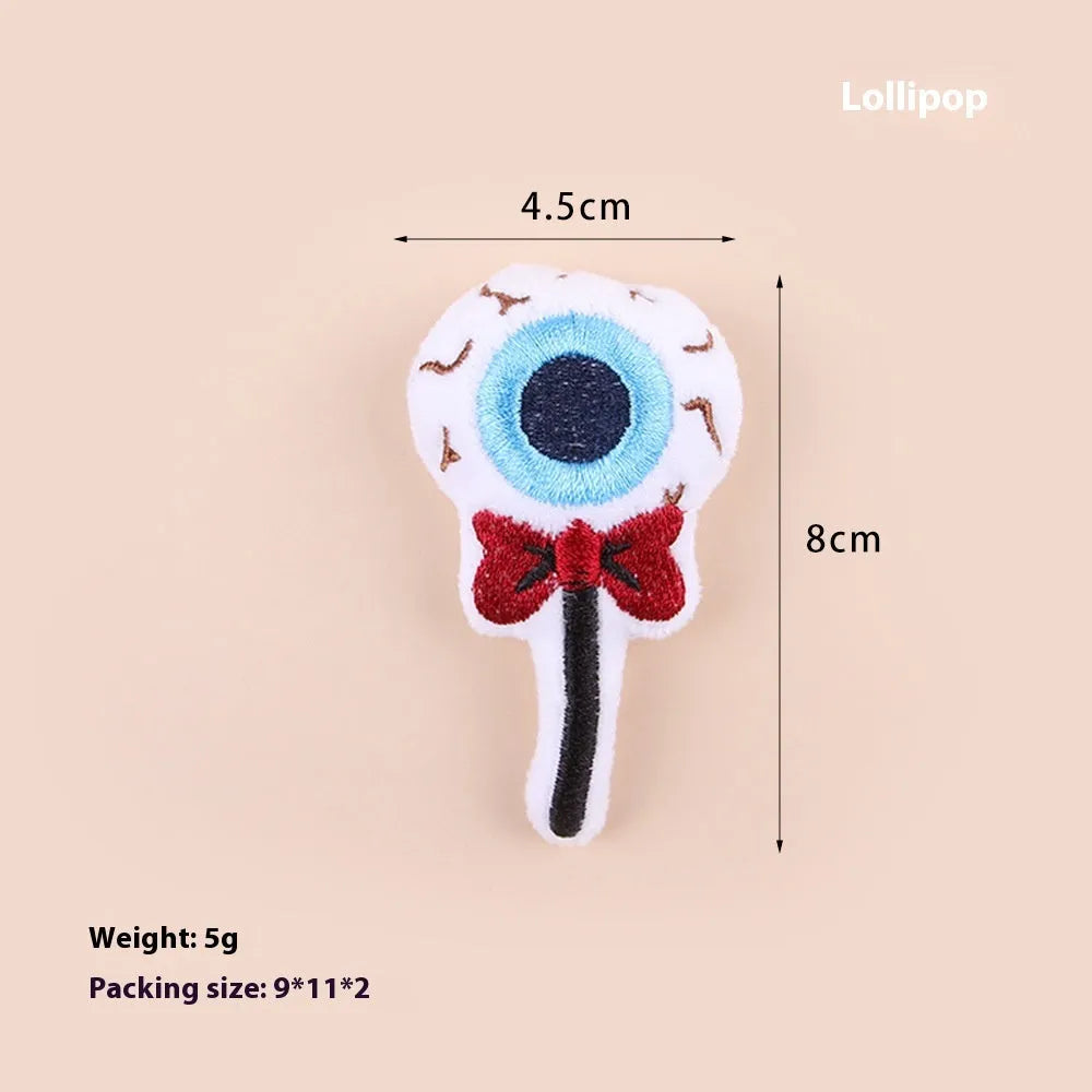 Plush cat teaser toy with long wand handle showing candy and skull designs