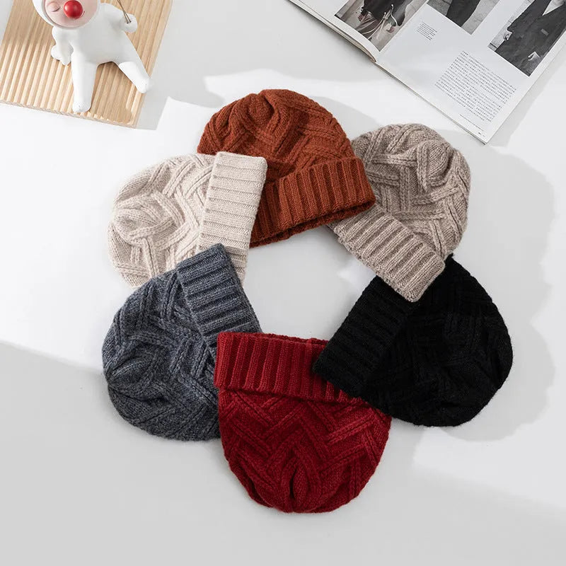 Women's wool knitted dome hat in various colours showing textured knit pattern and totem design elements