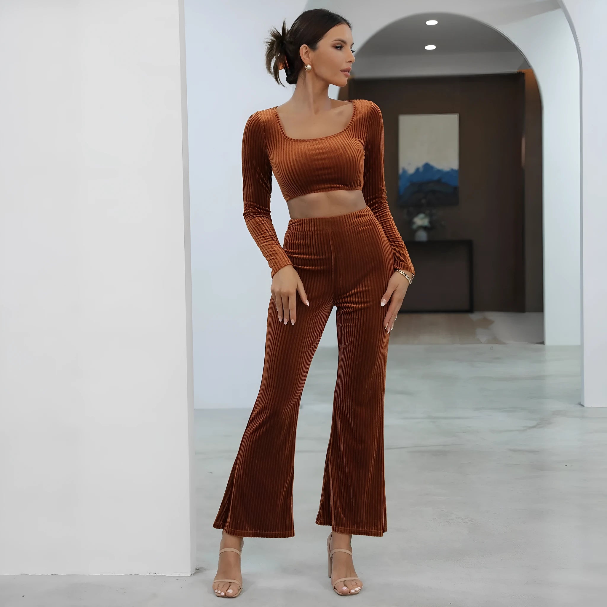 Caramel coloured long sleeve sweater and trousers casual set on a hanger.