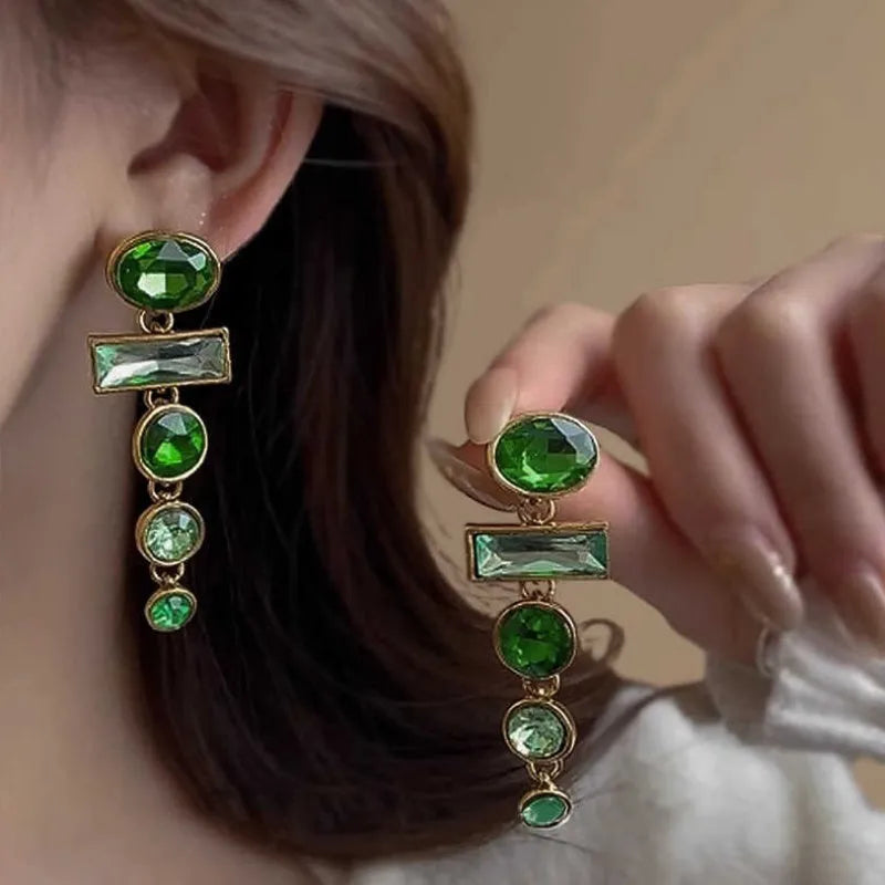 A pair of retro green gradient alloy earrings with geometric shapes and a long tassel design.