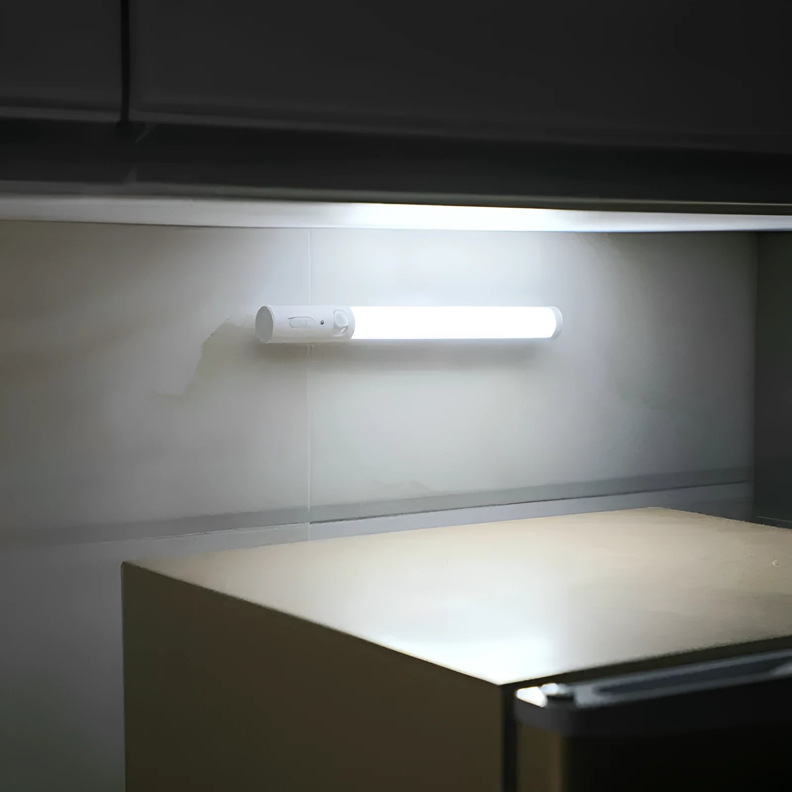 Battery-powered infrared sensor LED wall light with magnetic mount for cabinets.