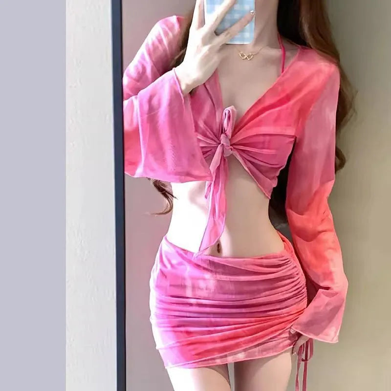 Women's blue high-waist bikini set with shirt, bra, underwear, and skirt laid flat.