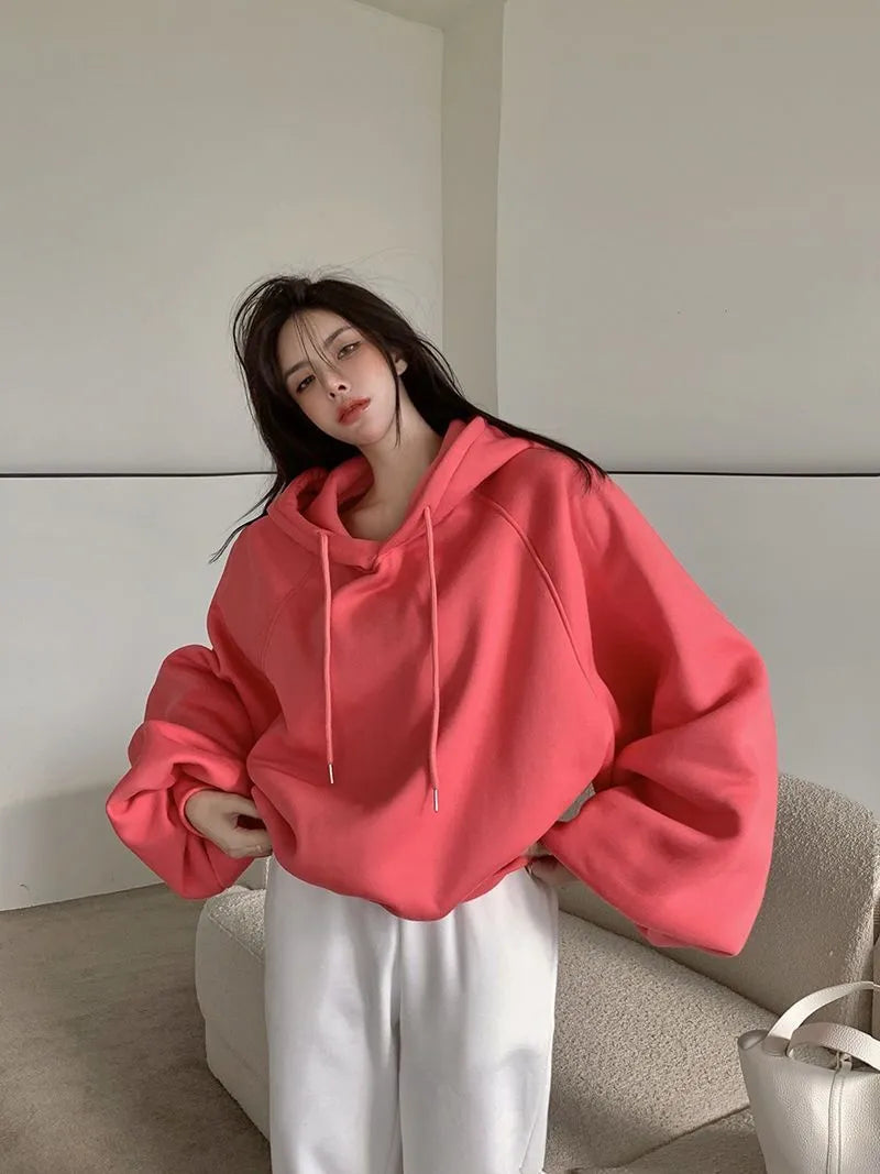 Watermelon red sleeveless women's hooded sweater made from mulberry silk, shown on a hanger.