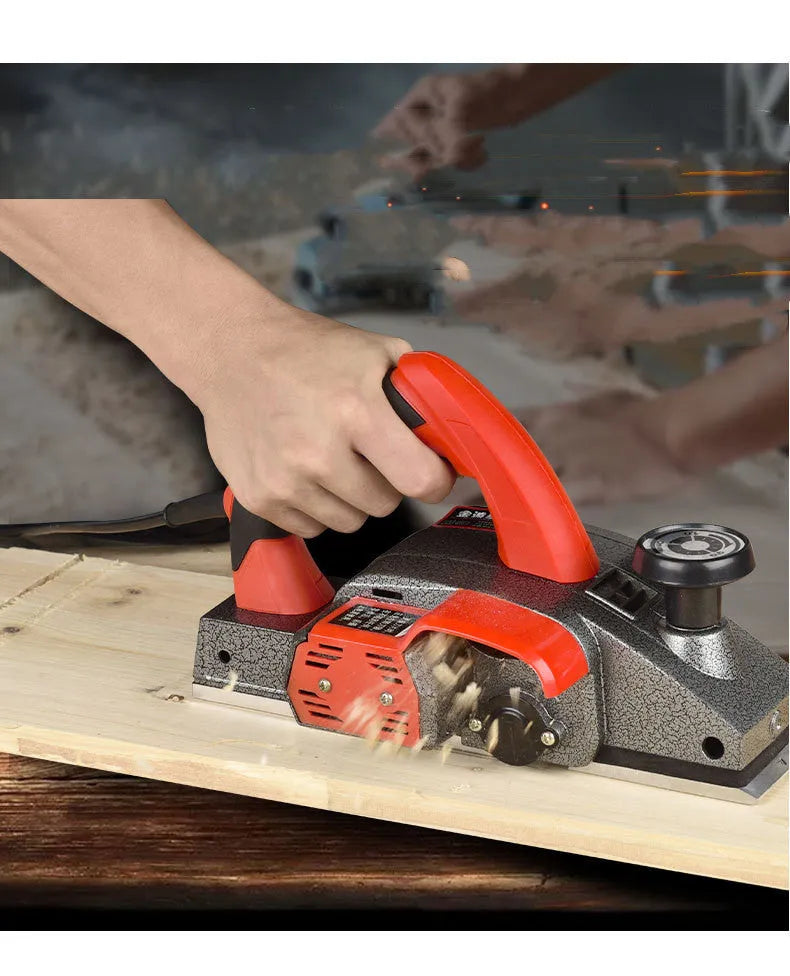 Red aluminium-shell electric wood planer with 82mm planing width on workbench