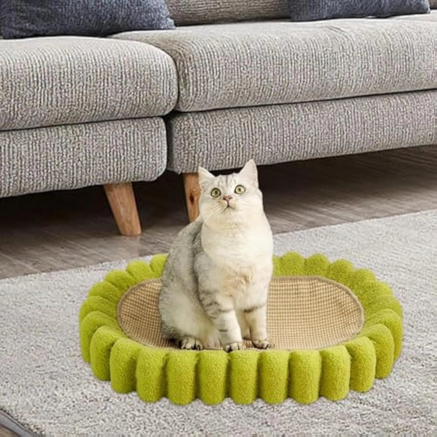 Green oval-shaped cat scratch pad and lounge bed made from textured sisal fabric.