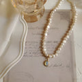 French Court vintage style pearl necklace with geometric pendant on an adjustable alloy chain.